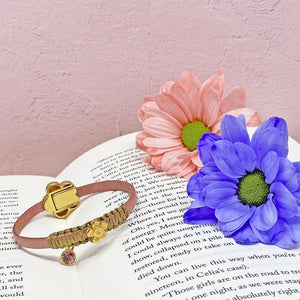Marguerite leather bracelet on book